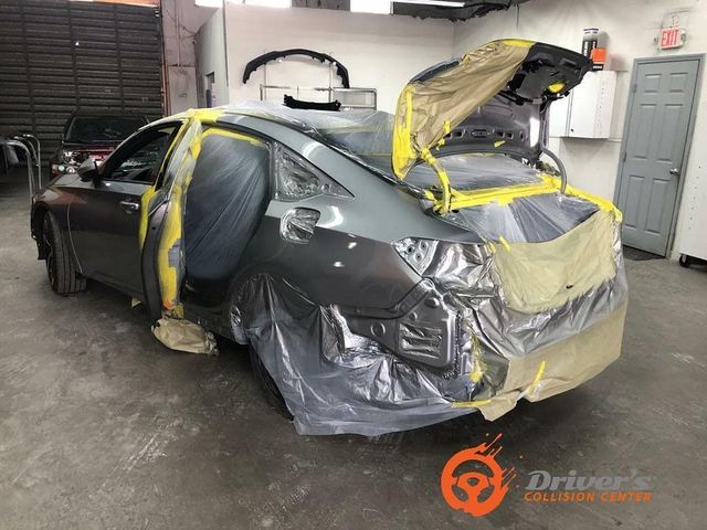 Car masked and prepped for paint in the booth