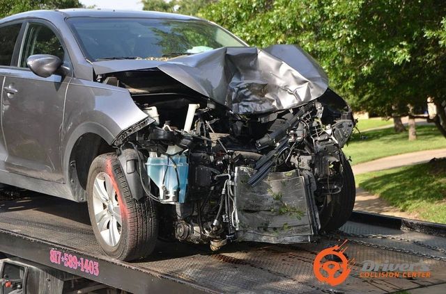Tow truck carrying a wrecked car